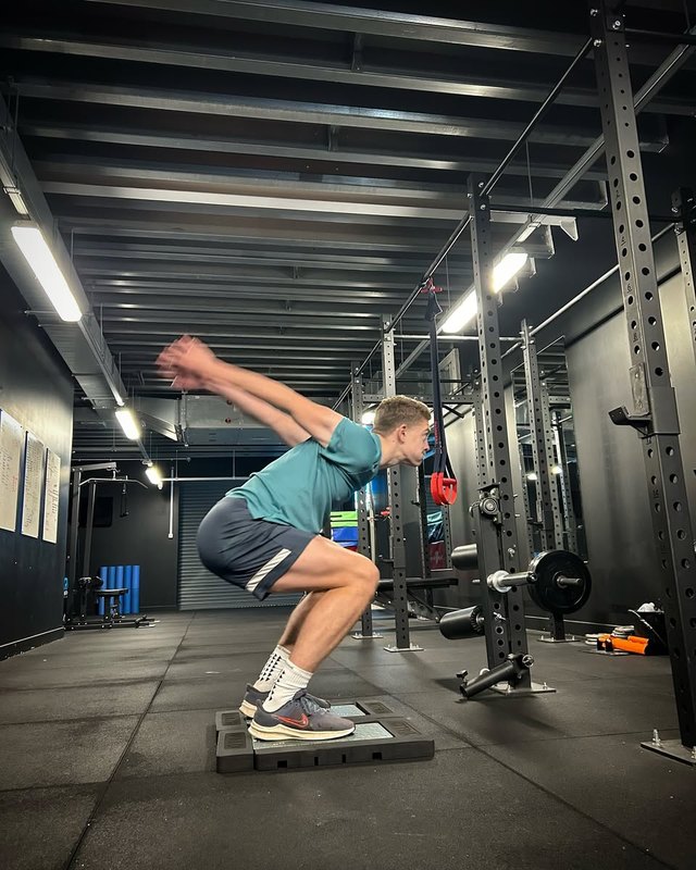Joe in the loaded squat phase before take-off